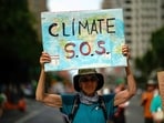 A man holds a sign