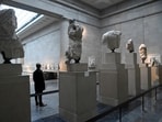An employee views examples of the Parthenon sculptures, sometimes referred to in the UK as the Elgin Marble.