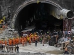 National Disaster Response Force (NDRF) personnel along with other rescue operatives gather near the face of the collapsed under construction Silkyara tunnel