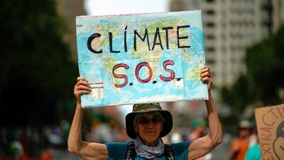 A man holds a sign (REUTERS)