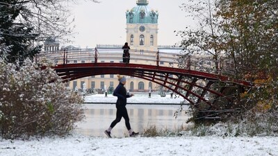 Germany Weather: People walk at the park after snowfall on the grounds of the Charlottenburg Castle in Berlin, Germany. (Reuters)