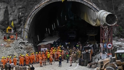 National Disaster Response Force (NDRF) personnel along with other rescue operatives gather near the face of the collapsed under construction Silkyara tunnel (AFP) National Disaster Response Force (NDRF) personnel along with other rescue operatives gather near the face of the collapsed under construction Silkyara tunnel (AFP)