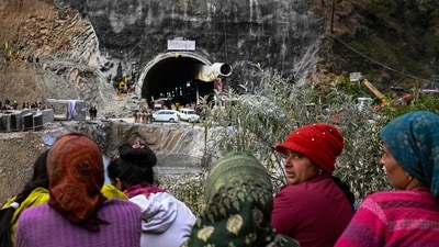 Villagers and locals gather to look at the efforts by the operatives to rescue the 41 men trapped inside the collapsed under construction Silkyara tunnel in the Uttarkashi district of India's Uttarakhand state on November 28, 2023. Indian rescue teams digging by hand are on the verge of breaking through to reach 41 men trapped in a collapsed road tunnel, officials said Tuesday, raising hopes the end of the marathon 17-day operation is in sight. (Photo by Sajjad HUSSAIN / AFP) (AFP) Villagers and locals gather to look at the efforts by the operatives to rescue the 41 men trapped inside the collapsed under construction Silkyara tunnel in the Uttarkashi district of India's Uttarakhand state on November 28, 2023. Indian rescue teams digging by hand are on the verge of breaking through to reach 41 men trapped in a collapsed road tunnel, officials said Tuesday, raising hopes the end of the marathon 17-day operation is in sight. (Photo by Sajjad HUSSAIN / AFP) (AFP)