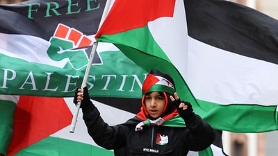 Israel-Hamas War: A boy holds a Palestinian flag at a demonstration in support of Palestinians in Frankfurt, Germany. (Reuters)