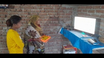 Manjeet Chauhan’s mother holding sweets with eyes on the TV set on Tuesday. (Sourced) Manjeet Chauhan’s mother holding sweets with eyes on the TV set on Tuesday. (Sourced)