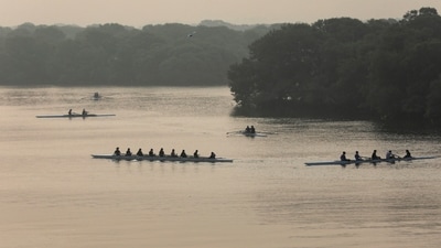 People are silhouetted as they row team boats amid smog, as air pollution levels rise in Karachi, Pakistan, (REUTERS)