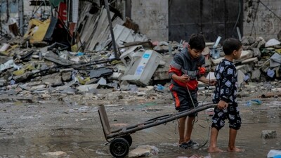 Israel-Hamas War: Palestinian children walk amid debris of buildings hit in Israeli strikes, near Al-Zawiya market in Gaza City. (AFP) Israel-Hamas War: Palestinian children walk amid debris of buildings hit in Israeli strikes, near Al-Zawiya market in Gaza City. (AFP)
