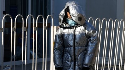 China Pneumonia Outbreak: A child wearing mask passes by a children's hospital in Beijing. (AP) China Pneumonia Outbreak: A child wearing mask passes by a children's hospital in Beijing. (AP)