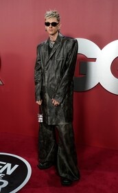Machine Gun Kelly wears a leather overcoat for a red carpet event. Machine Gun Kelly wears a leather overcoat for a red carpet event.