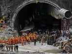 National Disaster Response Force (NDRF) personnel along with other rescue operatives gather near the face of the collapsed under construction Silkyara tunnel