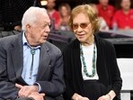 Jimmy Carter and Rosalynn Carter sit together ahead of an NFL football game between the Atlanta Falcons and the Cincinnati Bengals, Sept. 30, 2018, in Atlanta (AP Photo/John Amis, File)