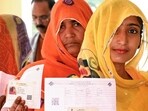 Voters stand in a queue to cast their vote for the Rajasthan Assembly elections(HT_PRINT)