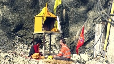 Arnold Dix on Tuesday sat in front of the makeshift temple in Uttarkashi. On Tuesday, the mission met success and all 41 workers were rescued. (ANI)