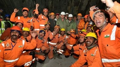 Uttarakhand Chief Minister Pushkar Singh Dhami met with National Disaster Response Force (NDRF) personnel who safely evacuated workers trapped inside the Silkyara tunnel, on Tuesday. (X/Pushkar Singh Dhami) Uttarakhand Chief Minister Pushkar Singh Dhami met with National Disaster Response Force (NDRF) personnel who safely evacuated workers trapped inside the Silkyara tunnel, on Tuesday. (X/Pushkar Singh Dhami)