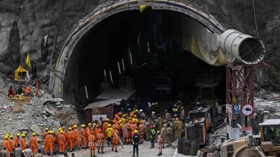 National Disaster Response Force (NDRF) personnel along with other rescue operatives gather near the face of the collapsed under construction Silkyara tunnel (AFP) National Disaster Response Force (NDRF) personnel along with other rescue operatives gather near the face of the collapsed under construction Silkyara tunnel (AFP)