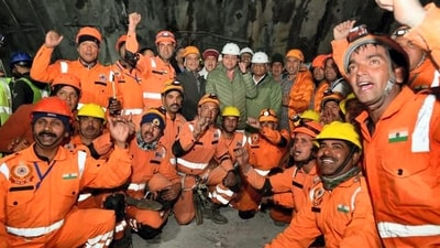 Rescue officials with Uttarakhand chief minister Pushkar Singh Dhami and Union minister of State VK Singh after the successful completion of the rescue mission. (PTI) Rescue officials with Uttarakhand chief minister Pushkar Singh Dhami and Union minister of State VK Singh after the successful completion of the rescue mission. (PTI)