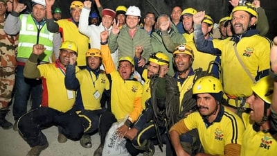 Uttarakhand Chief Minister Pushkar Singh Dhami and Union Minister of State VK Singh with rescue officials after the successful evacuation of 41 workers from the collapsed Silkyara Tunnel. (PTI) Uttarakhand Chief Minister Pushkar Singh Dhami and Union Minister of State VK Singh with rescue officials after the successful evacuation of 41 workers from the collapsed Silkyara Tunnel. (PTI)