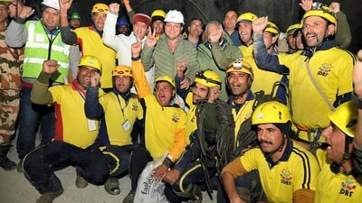 Uttarakhand Chief Minister Pushkar Singh Dhami and Union Minister of State VK Singh with rescue officials after the successful evacuation of 41 workers from the collapsed Silkyara Tunnel. (PTI) Uttarakhand Chief Minister Pushkar Singh Dhami and Union Minister of State VK Singh with rescue officials after the successful evacuation of 41 workers from the collapsed Silkyara Tunnel. (PTI)