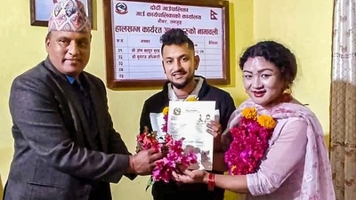Maya Gurung and Surendra Pandey receive their marriage certificate after legally registering same-sex marriage, at Dordi Rural Municipality of Lamjung district in Western Nepal. (PTI) Maya Gurung and Surendra Pandey receive their marriage certificate after legally registering same-sex marriage, at Dordi Rural Municipality of Lamjung district in Western Nepal. (PTI)