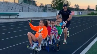 Chad pushing the stroller with his five kids for the world record. (GWR) Chad pushing the stroller with his five kids for the world record. (GWR)