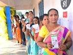 Voters stand in a queue to cast their vote for the Telangana assembly elections, in Nagarkurnool District on Thursday.