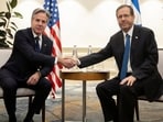 Israel's President Isaac Herzog, right and US Secretary of State Antony Blinken shake hands, during a meeting in Tel Aviv.