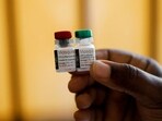 A nurse holds malaria vaccine vials before administering it to an infant at the Lumumba Sub-County hospital in Kisumu, Kenya.