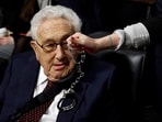 FILE PHOTO: A Code Pink demonstrator dangles a set of handcuffs in front of former United States Secretary of State Henry Kissinger at the Armed Services Committee on global challenges and U.S. national security strategy on Capitol Hill in Washington, U.S. January 29, 2015. REUTERS/Gary Cameron/File Photo