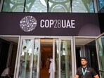 People walk past a COP28 sign at the venue of the United Nations climate summit in Dubai(AFP)