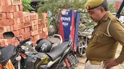 A police officer inspects the motorcycle involved in the accident on Wednesday night. (Sakib ALi/HT Photo) A police officer inspects the motorcycle involved in the accident on Wednesday night. (Sakib ALi/HT Photo)