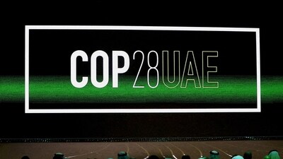 'COP28 UAE' logo is displayed on the screen during the opening ceremony of Abu Dhabi Sustainability Week (ADSW). (REUTERS)