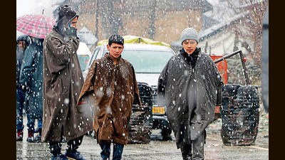 Children in warm clothes walk amid fresh snow on Mughal Road on Thursday (ANI) Children in warm clothes walk amid fresh snow on Mughal Road on Thursday (ANI)