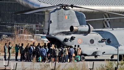 Rescued workers board an Indian Air Force (IAF) Chinook helicopter to be airlifted to Rishikesh, at Chinyalisaur airstrip, in Uttarkashi district. (AP) Rescued workers board an Indian Air Force (IAF) Chinook helicopter to be airlifted to Rishikesh, at Chinyalisaur airstrip, in Uttarkashi district. (AP)