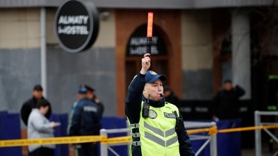 Emergency specialists work at the site of a fire at a hostel in Almaty, Kazakhstan. (REUTERS)