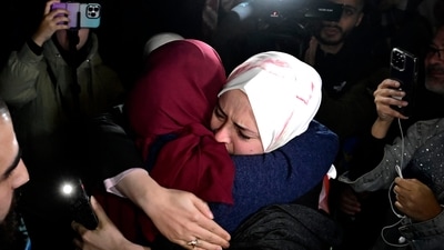 A newly released prisoner greets a relative during a welcome ceremony following the release of Palestinian prisoners from Israeli jails in exchange for Israeli hostages. (AFP) A newly released prisoner greets a relative during a welcome ceremony following the release of Palestinian prisoners from Israeli jails in exchange for Israeli hostages. (AFP)