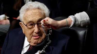 FILE PHOTO: A Code Pink demonstrator dangles a set of handcuffs in front of former United States Secretary of State Henry Kissinger at the Armed Services Committee on global challenges and U.S. national security strategy on Capitol Hill in Washington, U.S. January 29, 2015. REUTERS/Gary Cameron/File Photo (REUTERS)