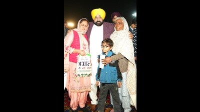 Punjab chief minister Bhagwant Mann after handing over a cheques of ex gratia to a slain cop’s family. (Photo: X)