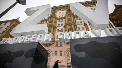 A man walks past huge Z and V letters - tactical insignias of Russian troops in Ukraine, placed in front of the US Embassy in central Moscow. (AFP)