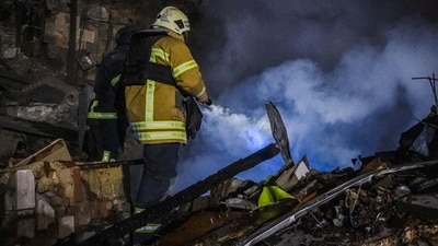 Rescuers work at a site of a residential building heavily damaged by a Russian missile strike, amid Russia's attack on Ukraine, in the town of Novohrodivka, Donetsk region. (via REUTERS)