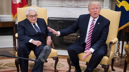 Ex-US President Donald Trump speaks with former US Secretary of State Henry Kissinger during a meeting in the Oval Office of the White House in Washington, in 2017.&nbsp;(AFP)