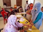 A voter gets her finger marked with indelible ink as she casts her vote for the Madhya Pradesh Assembly elections on Friday. (ANI Photo)(Ravi Upadhyay)