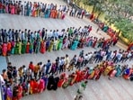 People wait in queues to cast their votes at a polling booth for Madhya Pradesh Assembly elections in Bhopal on Friday. (ANI Photo)(Sanjeev Gupta)