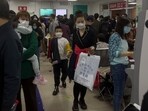 Parents with their children wait at a crowded holding room of a children's hospital in Beijing Parents with their children wait at a crowded holding room of a children's hospital in Beijing