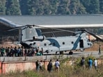 Workers who were rescued from a tunnel that collapsed board an Indian Air Force (IAF) Chinook helicopter to be airlifted to Rishikesh, at Chinyalisaur airstrip, in Uttarkashi. (AP)