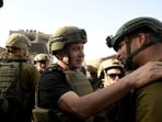 Israel's Prime Minister Benjamin Netanyahu greets soldiers as he visits the Gaza Strip. 