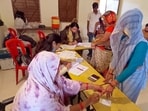 MP election results 2023: A voter gets her finger marked with indelible ink as she casts her vote for the Madhya Pradesh Assembly elections.(ANI)