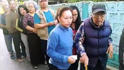 An elderly voter being assisted on his arrival to cast his vote for the Mizoram assembly elections, at a polling station, in Aizawl. (ANI ) An elderly voter being assisted on his arrival to cast his vote for the Mizoram assembly elections, at a polling station, in Aizawl. (ANI )