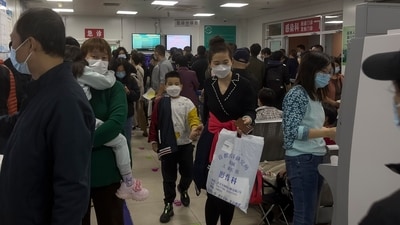 Parents with their children wait at a crowded holding room of a children's hospital in Beijing (AP) Parents with their children wait at a crowded holding room of a children's hospital in Beijing (AP)