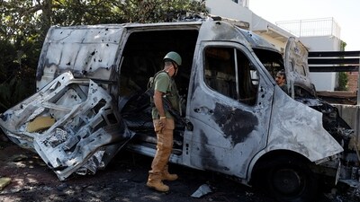 Israel-Hamas War: Security personnel check a car hit by a rocket fired today from the Gaza Strip,  after a temporary truce expired between Israel and Hamas. (Reuters)