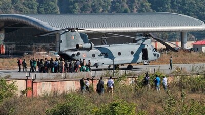 Workers who were rescued from a tunnel that collapsed board an Indian Air Force (IAF) Chinook helicopter to be airlifted to Rishikesh, at Chinyalisaur airstrip, in Uttarkashi. (AP)